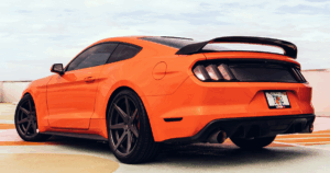 An orange car with window tint